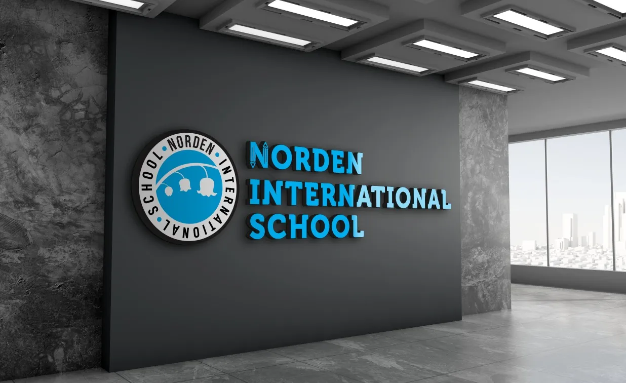The Norden International School of Helsinki emblem and wordmark, mounted on a wall